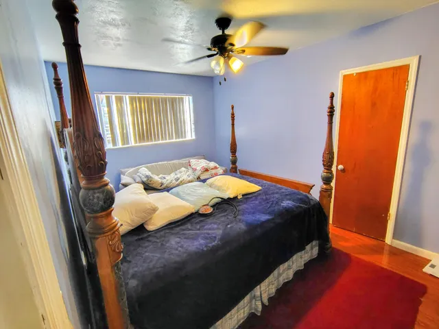 a bedroom with a bed dresser and a window