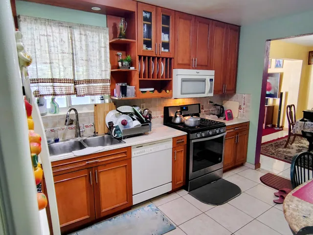 a kitchen with stainless steel appliances granite countertop a stove sink and cabinets