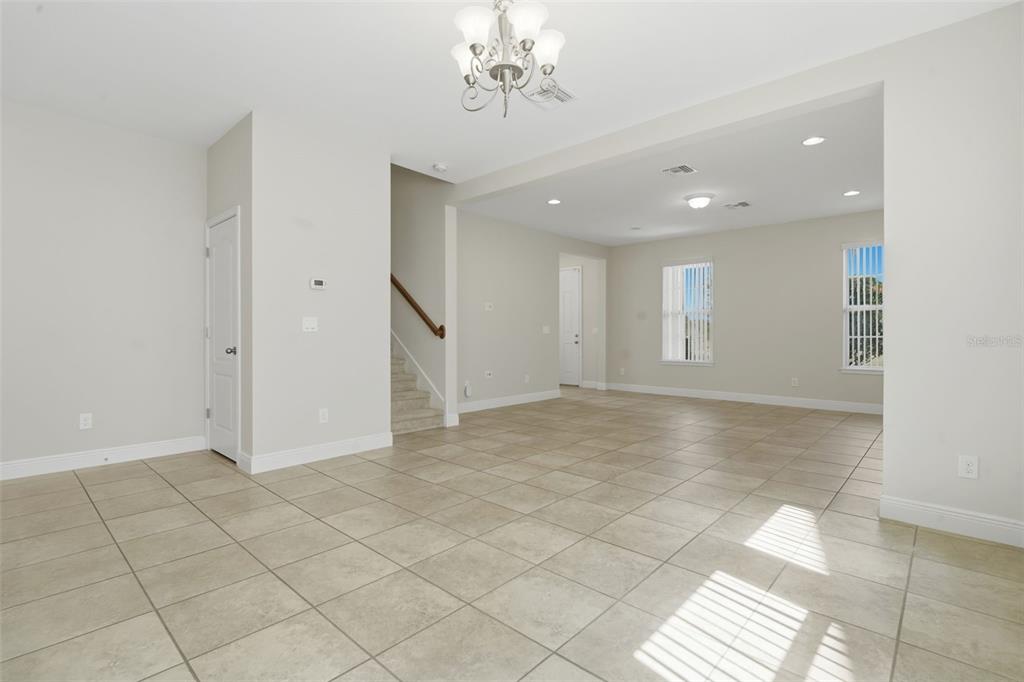 11486 Misty Oak Alley Windermere, FL 34786 - Photo 15 of 47 an empty room with windows and chandelier fan
