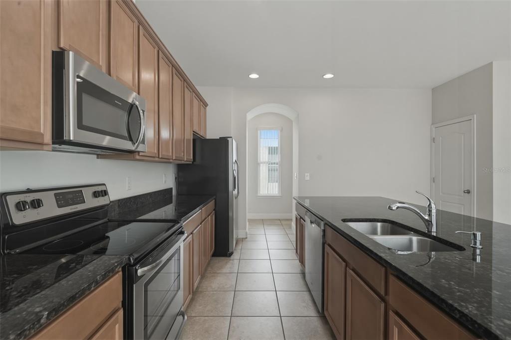11486 Misty Oak Alley Windermere, FL 34786 - Photo 18 of 47 a kitchen with a sink stove and cabinets