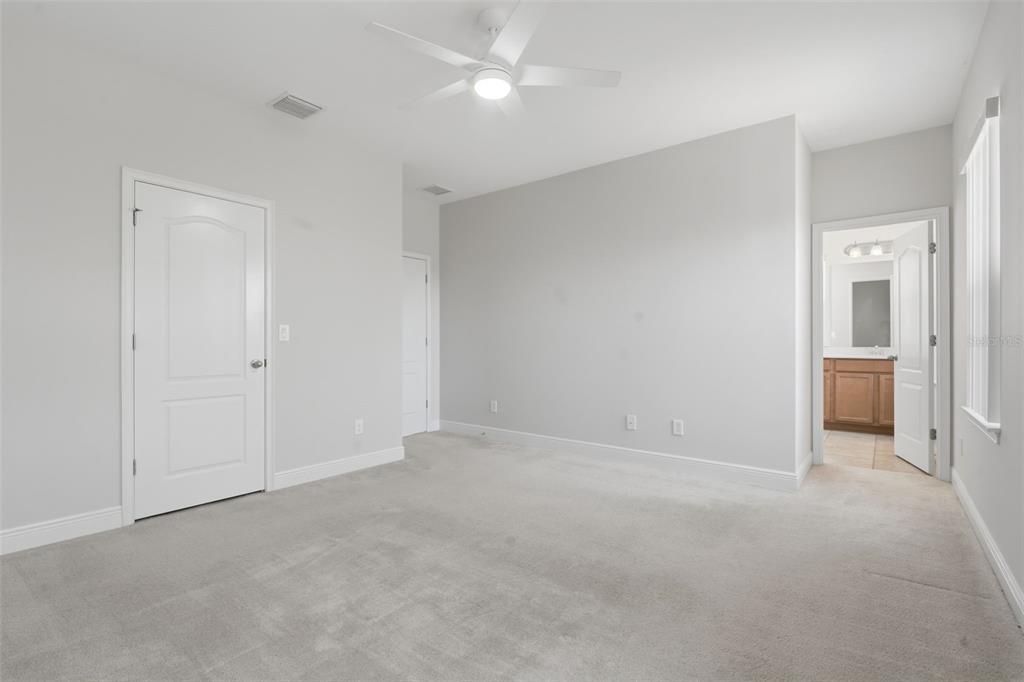 11486 Misty Oak Alley Windermere, FL 34786 - Photo 26 of 47 an empty room with fan and windows