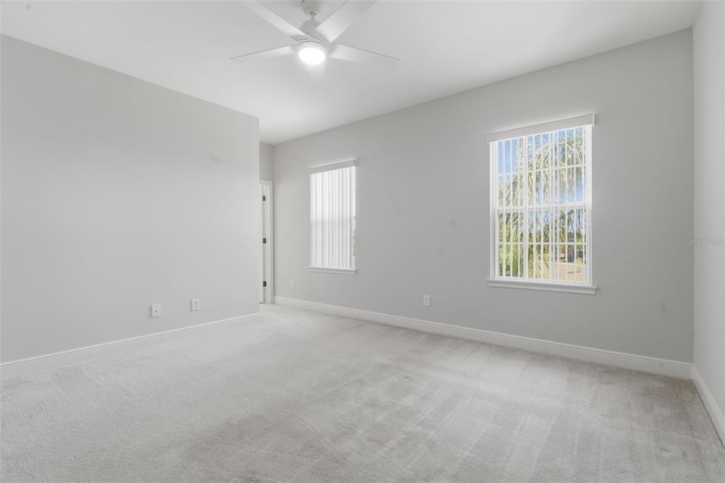 11486 Misty Oak Alley Windermere, FL 34786 - Photo 27 of 47 an empty room with a window and a fan