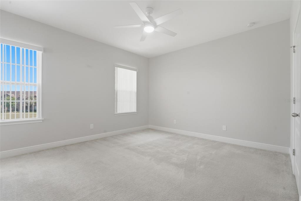 11486 Misty Oak Alley Windermere, FL 34786 - Photo 29 of 47 an empty room with a window and a fan