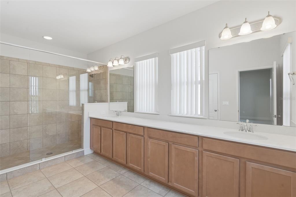 11486 Misty Oak Alley Windermere, FL 34786 - Photo 30 of 47 a bathroom with a double vanity sink mirror and shower