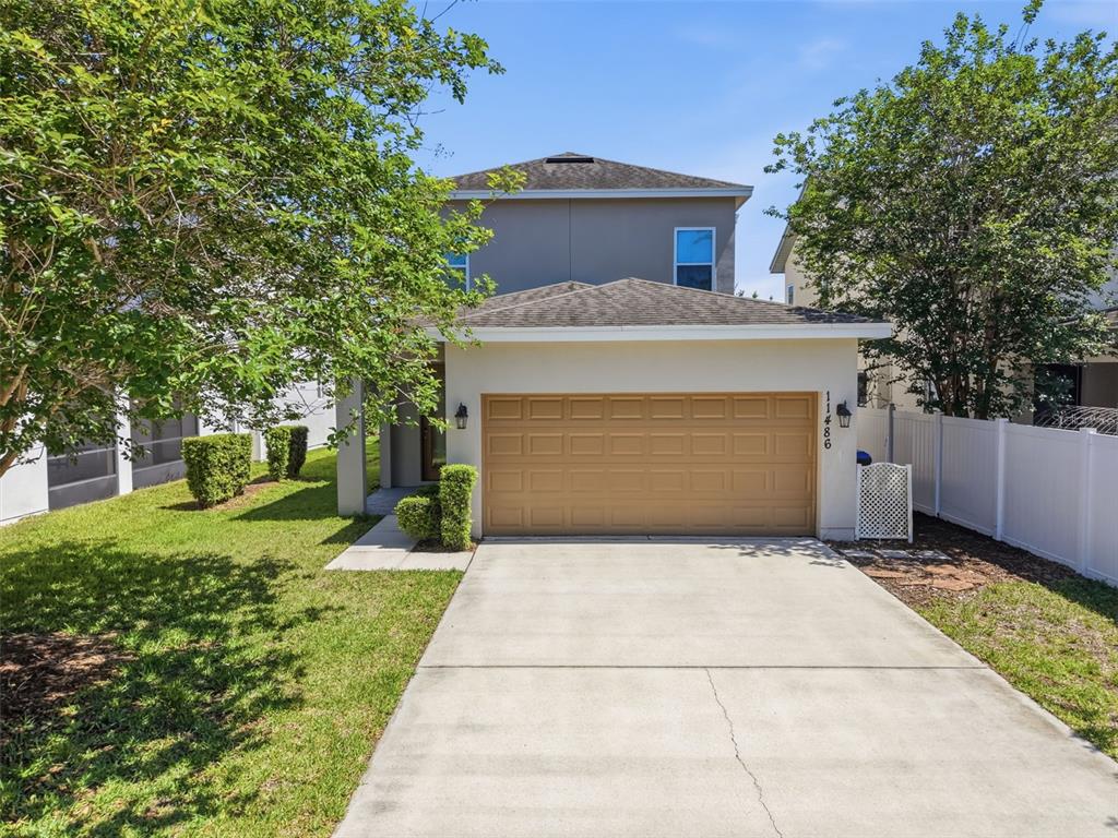11486 Misty Oak Alley Windermere, FL 34786 - Photo 39 of 47 a front view of a house with a yard and trees