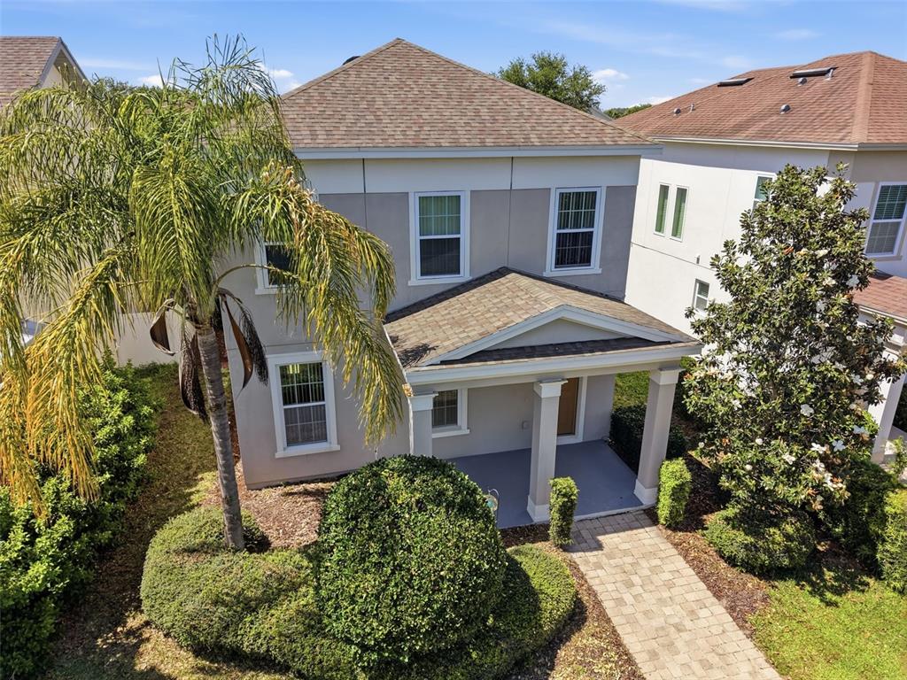 11486 Misty Oak Alley Windermere, FL 34786 - Photo 42 of 47 a view of a house with brick walls plants and large tree