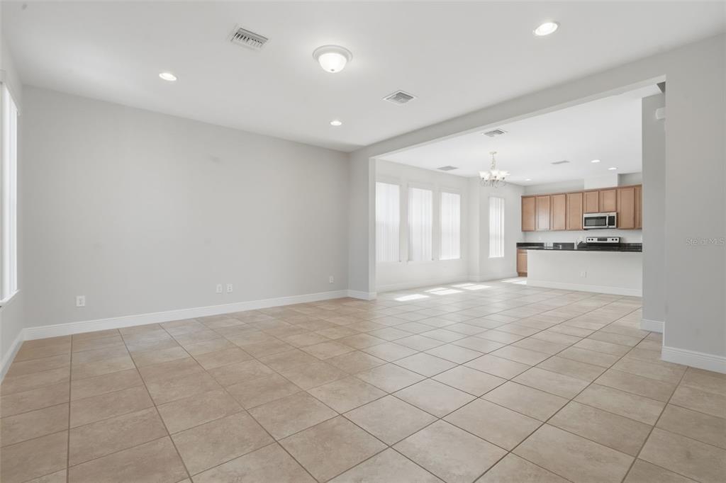 11486 Misty Oak Alley Windermere, FL 34786 - Photo 10 of 47 a view of an empty room with kitchen and window
