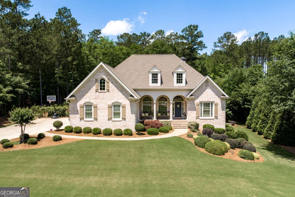 a front view of a house with a yard and porch