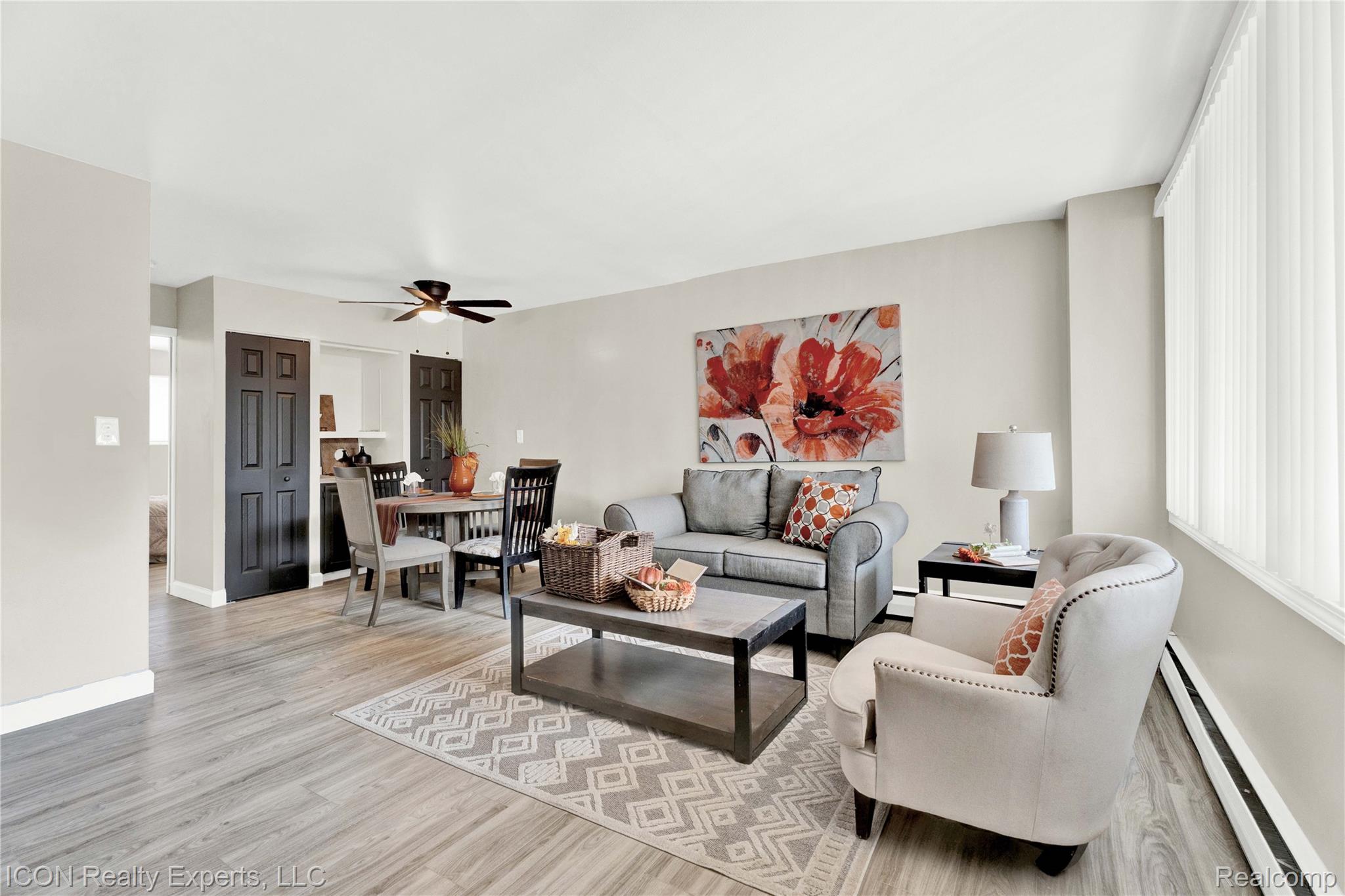 18400 Lahser Road Detroit, MI 48219 - Photo 1 of 22 Living room featuring a baseboard heating unit, light wood finished floors, and a ceiling fan