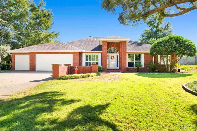 a front view of house with yard and green space