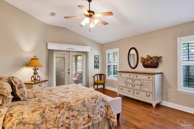 a bedroom with a bed a dresser and chair