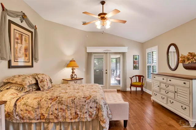 a bedroom with a bed and dresser with mirror