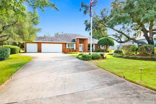 a front view of house with yard and green space