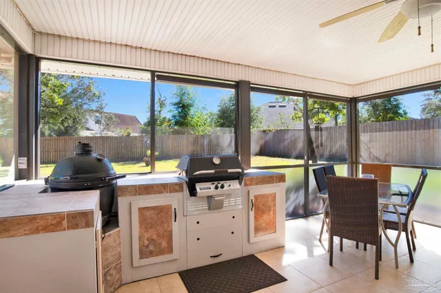 a kitchen with a stove a refrigerator a sink dining table and chairs