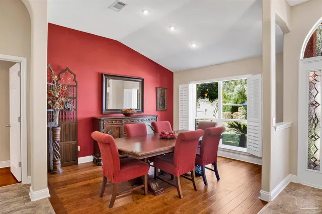 a dining room with furniture and wooden floor