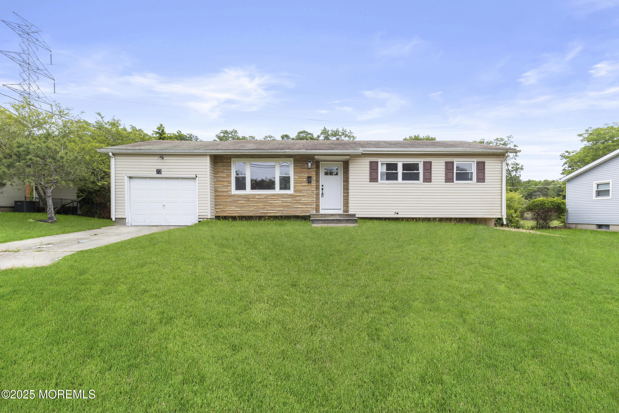 a front view of house with yard and green space