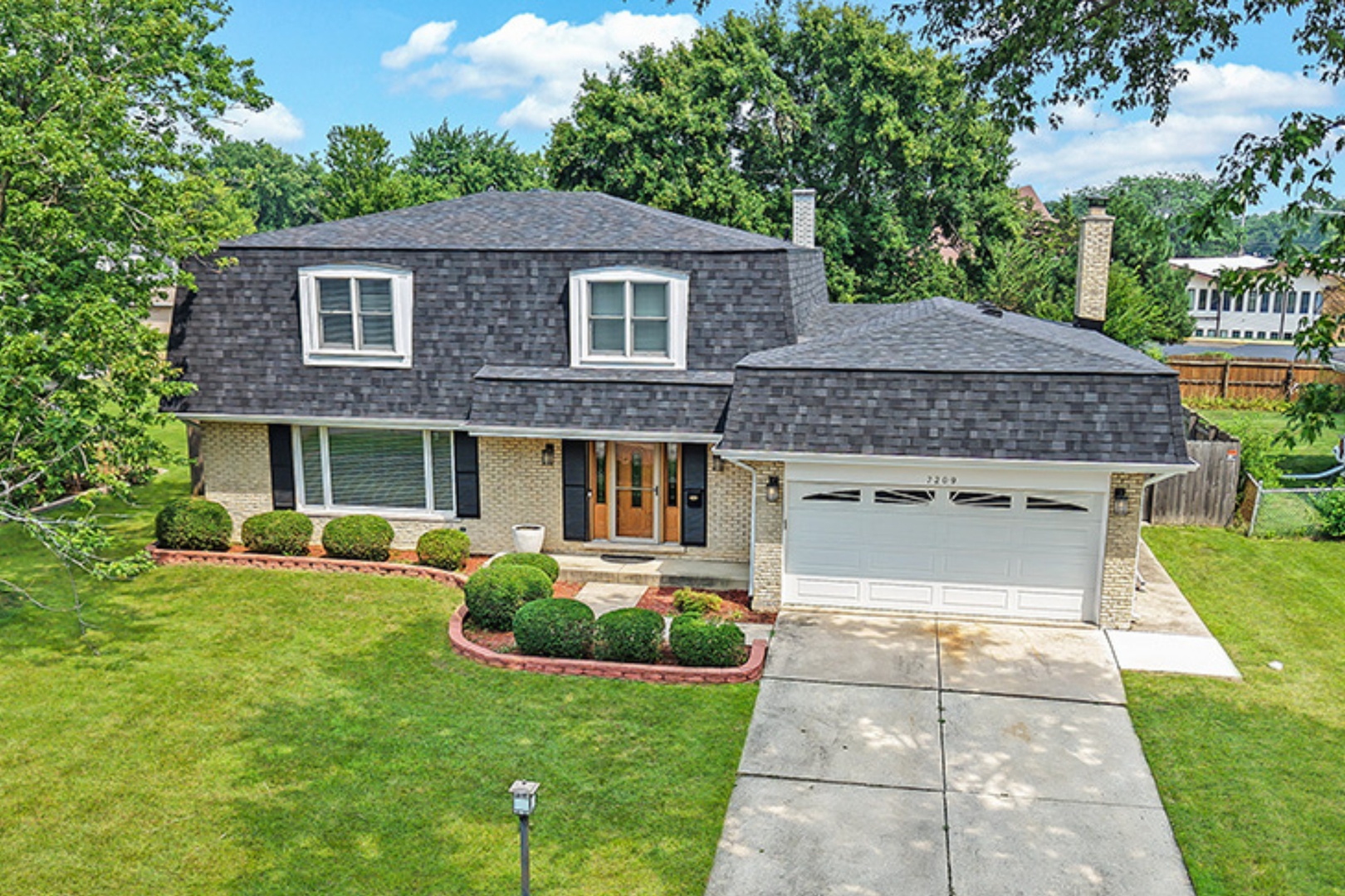 a front view of a house with garden