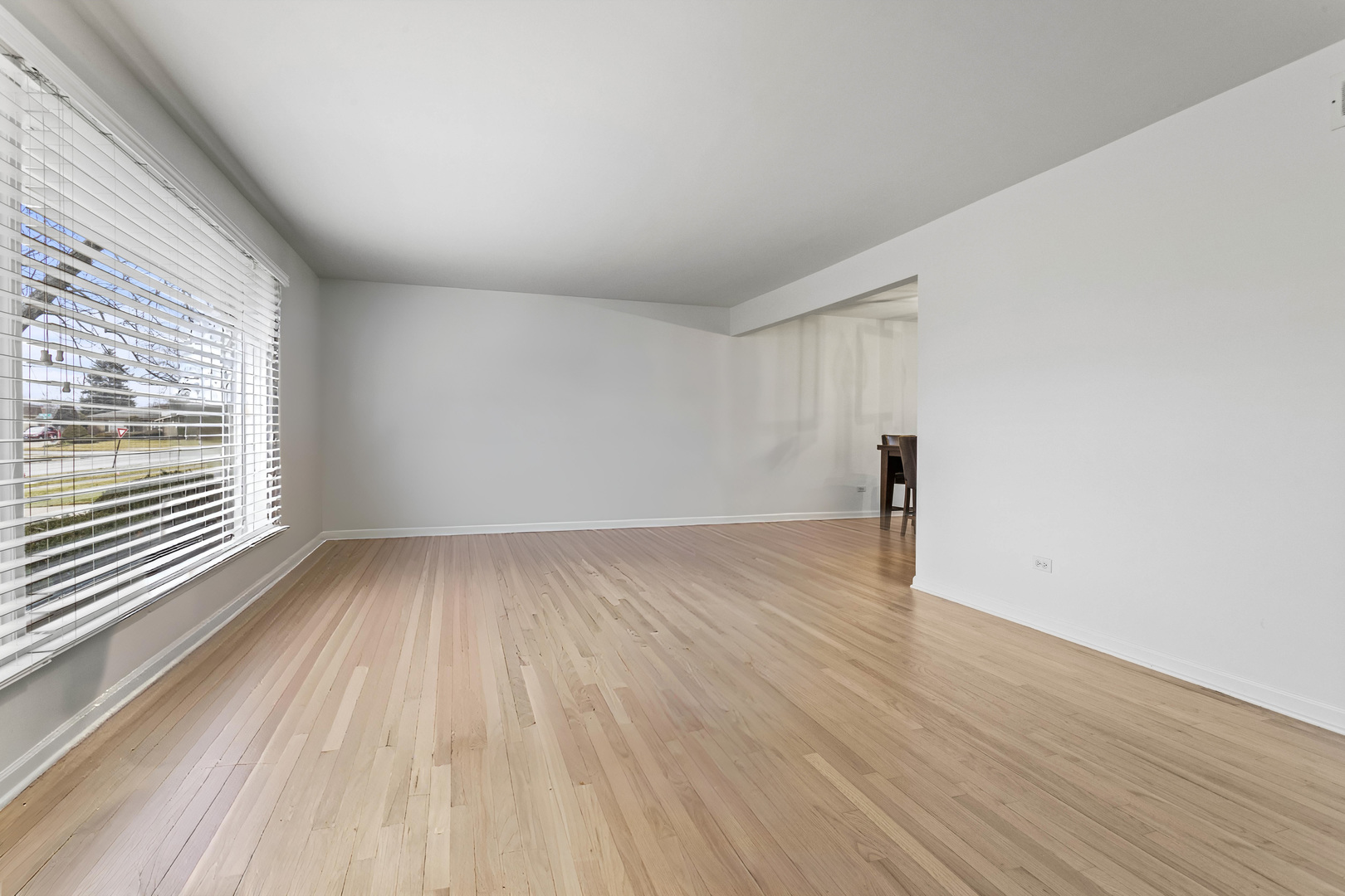 7209 Grant Street Darien, IL 60561 - Photo 11 of 36 a view of a room with wooden floor and window