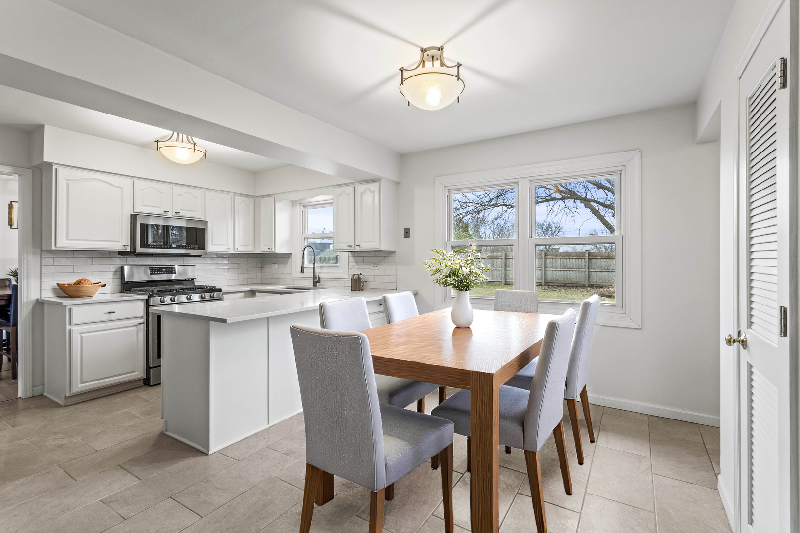 7209 Grant Street Darien, IL 60561 - Photo 16 of 36 a view of a dining room with furniture and a kitchen