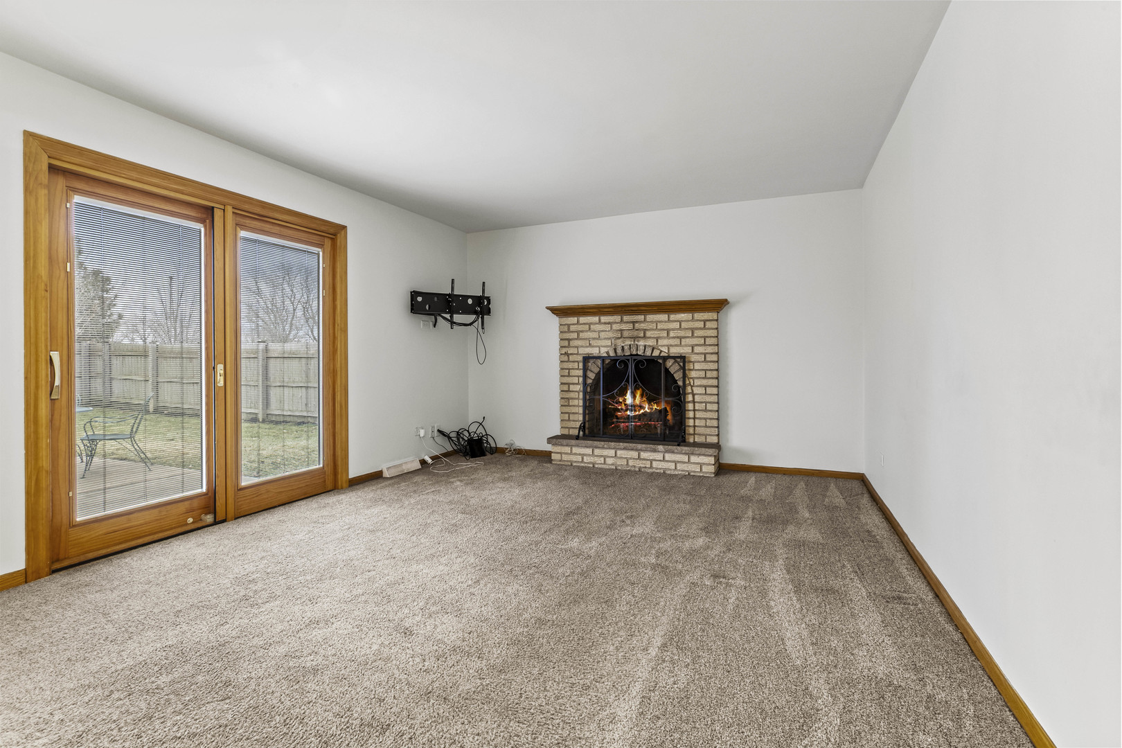 7209 Grant Street Darien, IL 60561 - Photo 18 of 36 an empty room with fireplace and a window