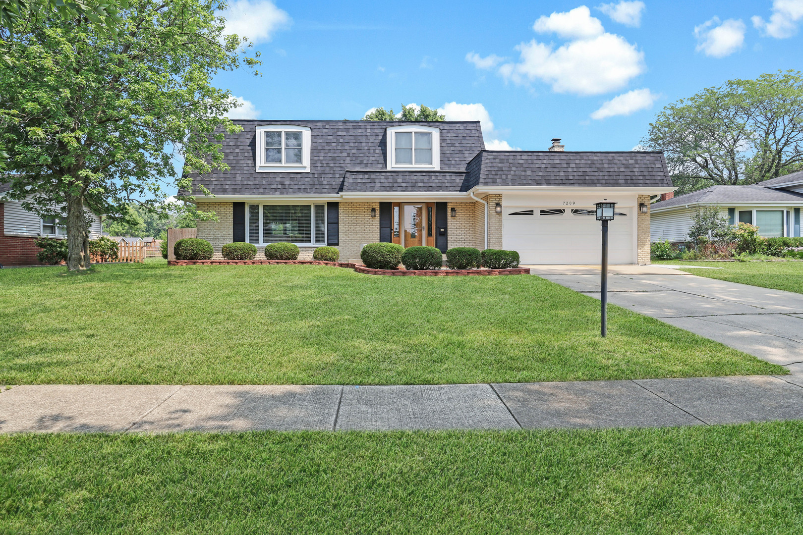 7209 Grant Street Darien, IL 60561 - Photo 2 of 36 a front view of a house with a yard