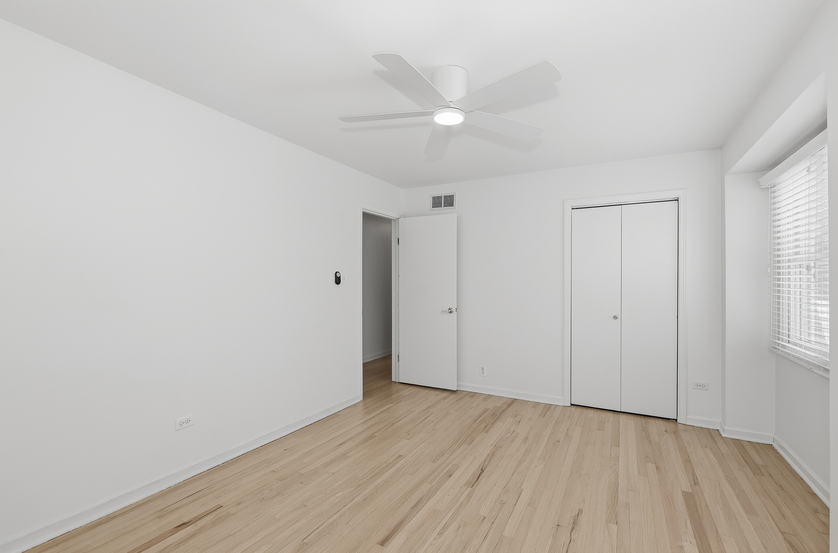 7209 Grant Street Darien, IL 60561 - Photo 26 of 36 an empty room with wooden floor and windows