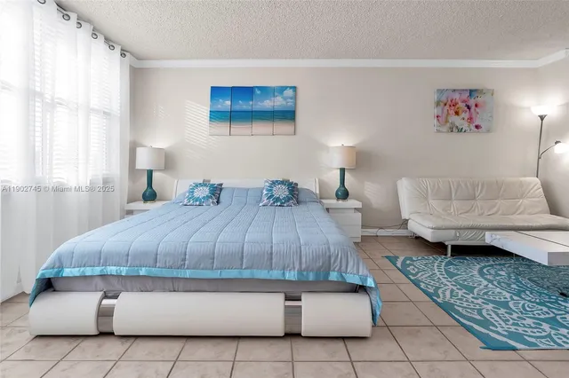 a bedroom with a bed and a couch