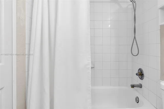 a bathroom with a shower and a bathtub