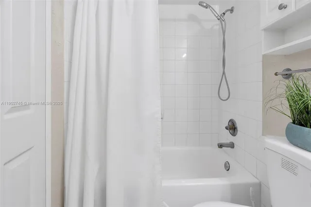 a bathroom with a shower and a bath tub