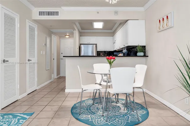 a living room with furniture and a dining table with kitchen view