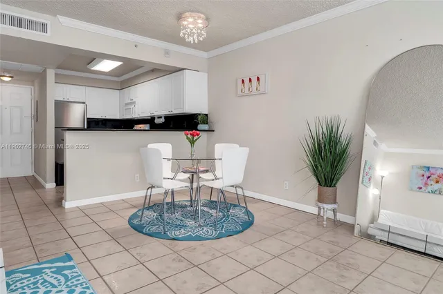 a dining room with furniture and a chandelier