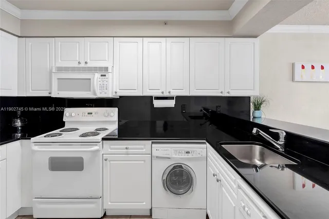 a kitchen with white cabinets sink and white appliances