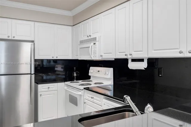 a kitchen with stainless steel appliances a refrigerator a stove a microwave and cabinets