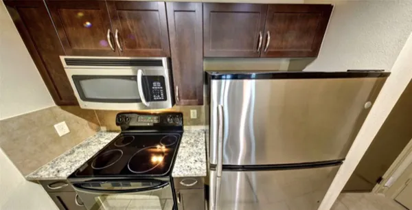a kitchen with a refrigerator and a stove