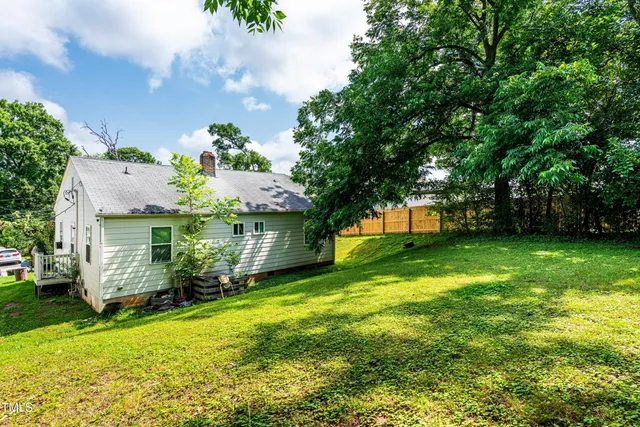 a front view of house with a garden
