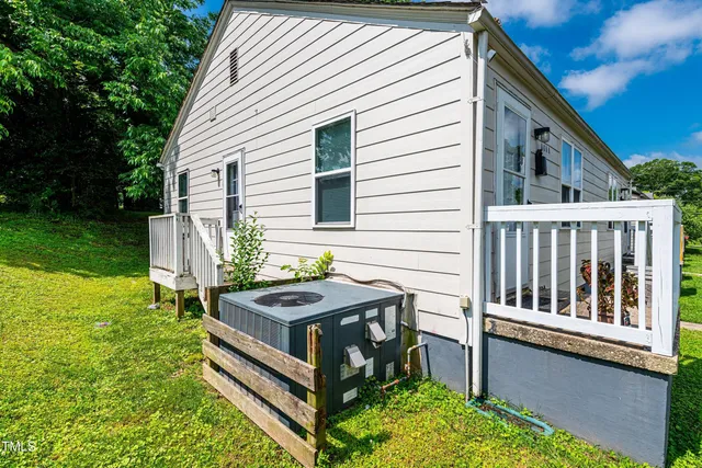 a view of backyard with deck and outdoor seating