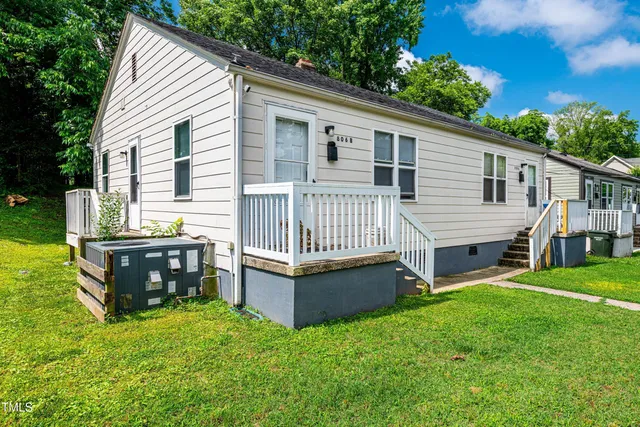 a view of a house with a yard and furniture
