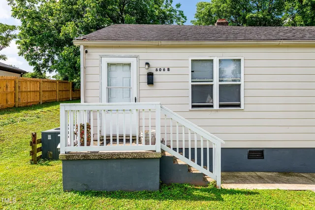 a view of front door and small yard