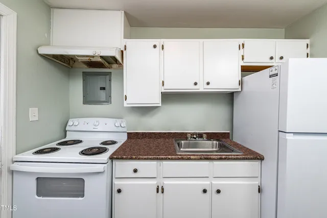 a stove top oven sitting inside of a kitchen