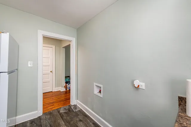 a view of a hallway with wooden floor and closet