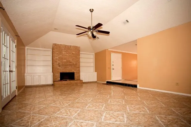 a view of a livingroom with a ceiling fan and window