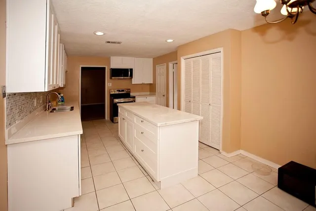 a kitchen with a sink a stove and a refrigerator