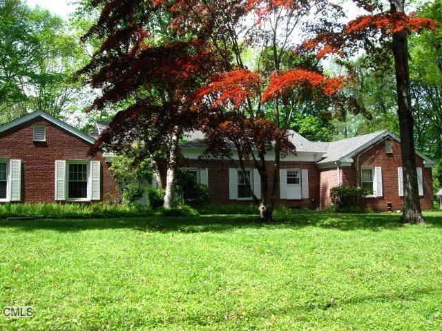 a front view of house with yard and green space