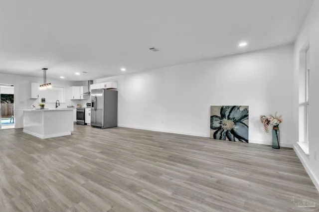 a view of a room with wooden floor and furniture