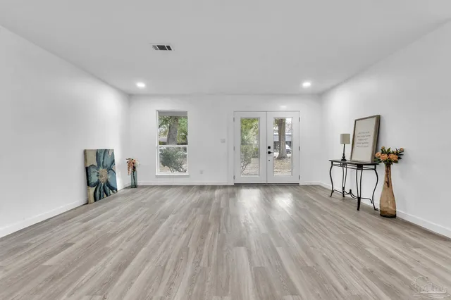 wooden floor in an empty room with a window