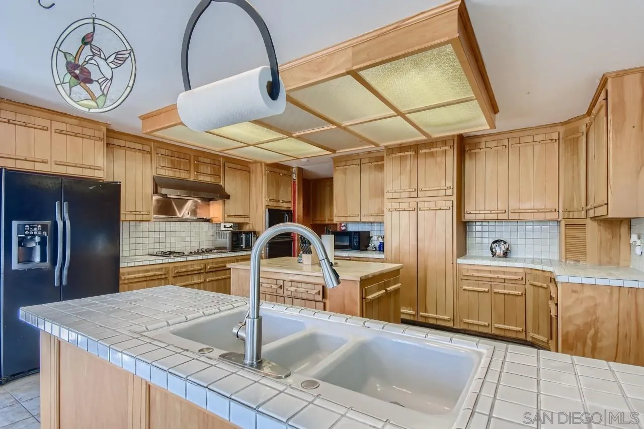 625 South Grade Road Alpine, CA 91901 - Photo 13 of 42 a kitchen with stainless steel appliances granite countertop a sink a counter top space cabinets and stainless steel appliances