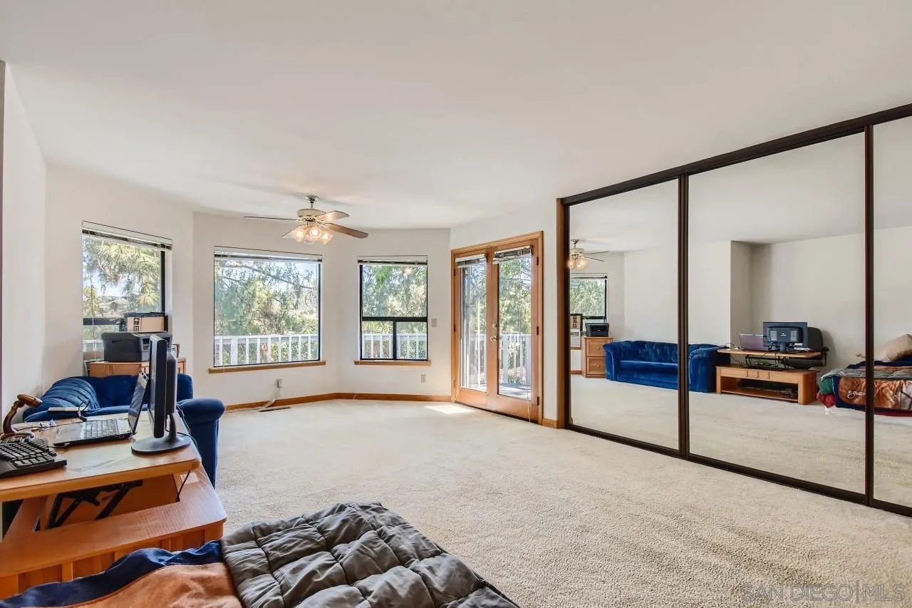 625 South Grade Road Alpine, CA 91901 - Photo 16 of 42 a spacious bedroom with a bed and a large window