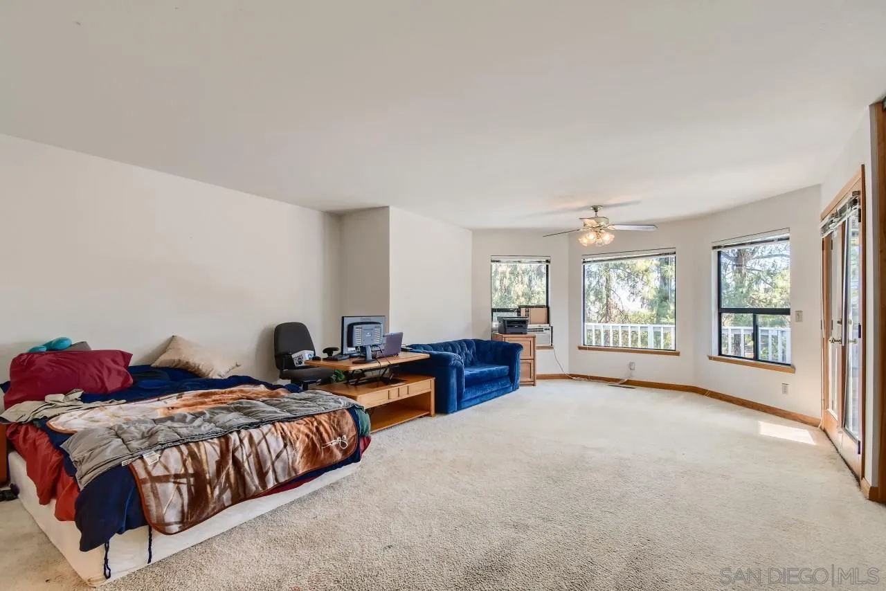 625 South Grade Road Alpine, CA 91901 - Photo 17 of 42 a spacious bedroom with a bed and a large window