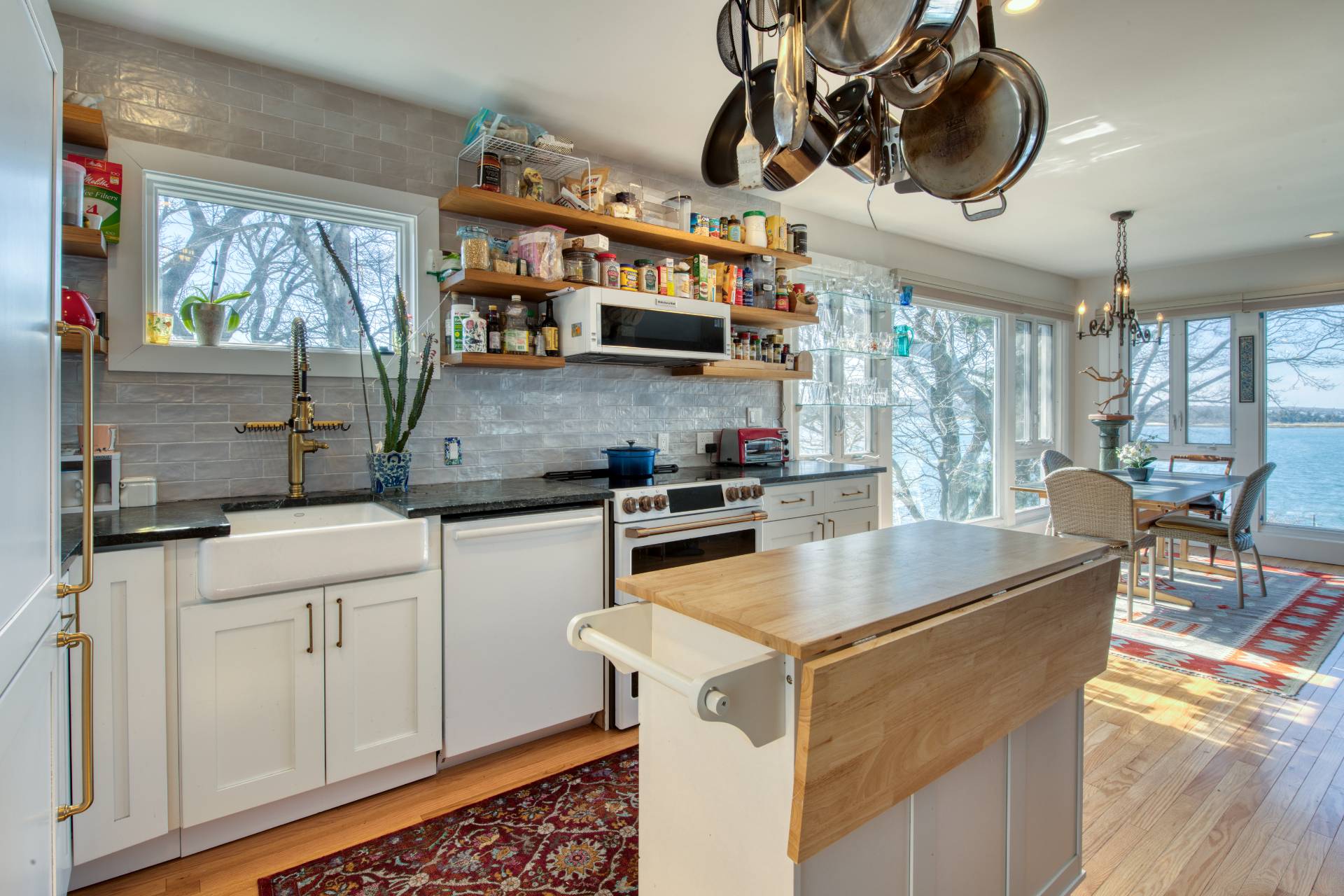 140 Redwood Road Sag Harbor, NY 11963 - Photo 3 of 14 a kitchen with stainless steel appliances granite countertop a sink a stove and a wooden floors