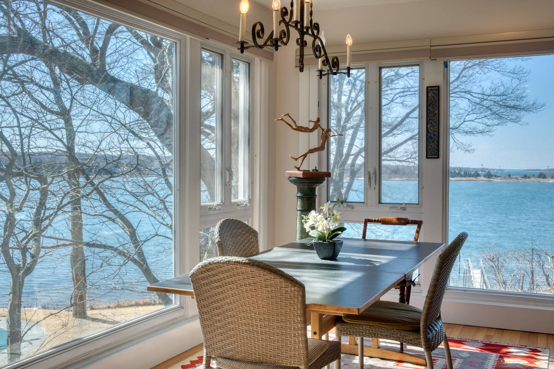 140 Redwood Road Sag Harbor, NY 11963 - Photo 4 of 14 a dining room with furniture a chandelier and wooden floor